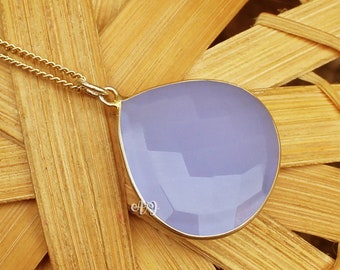 May include: A delicate gold chain necklace with a large, teardrop-shaped pendant made of lavender chalcedony.