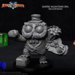 May include: A grey 3D printed miniature of a dapper owl wearing a top hat, bow tie, and tuxedo, holding a bouquet of flowers and a heart-shaped box. The miniature is pre-supported and is part of a Valentine's Day themed collection.