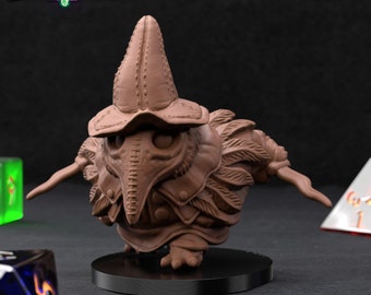 Puede incluir: Una miniatura marrón pre-soportada de una criatura similar a un cuervo que lleva un sombrero y una máscara de médico de la peste. La miniatura está de pie sobre una base negra. El texto "HUNTER OF CROWS PRE-SUPPORTED" es visible en la esquina superior derecha de la imagen.