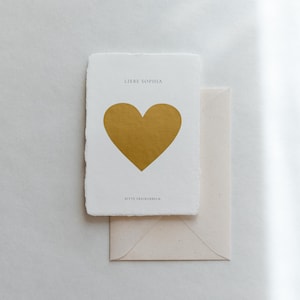 Scratch card with golden heart on handmade paper