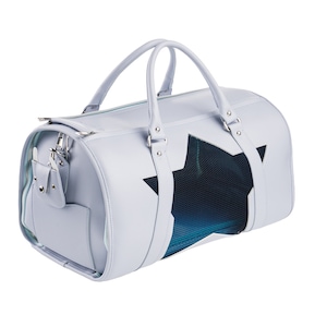 May include: A light blue travel carrier for pets with a star-shaped mesh window. The carrier has two top handles and a side pocket.