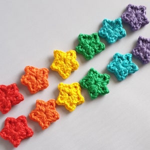 May include: A row of ten crocheted stars in rainbow colours, starting with purple and ending with red.