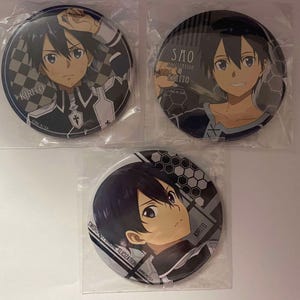 May include: Three round anime character pinback buttons. Each button features a different image of a character with black hair and a determined expression. The buttons are in clear plastic packaging.