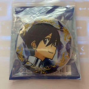 May include: A round button pin featuring an anime character with black hair and blue clothing. The pin is in a clear plastic bag. The pin has a gold floral design around the character's image. The background is blue and white.