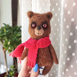 Funny little handmade teddy bear with red scarf and beautiful glass eyes