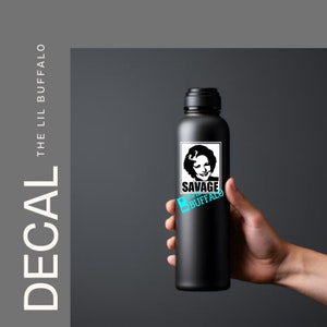 May include: Black water bottle with a white sticker featuring a woman's face and the text "Savage the Lil Buffalo".