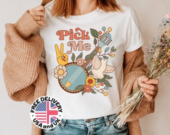 Könnte beinhalten: Weißes T-Shirt mit einem Retro-Grafikdesign mit einem Peace-Zeichen, einem Banjo, einer Taube und dem Text "Pick Me".