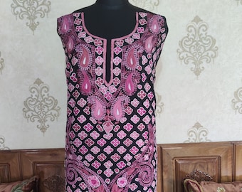 May include: A black sleeveless tunic with pink embroidery featuring paisley and floral patterns. The embroidery is intricate and detailed, and the tunic is a beautiful example of traditional Indian craftsmanship.