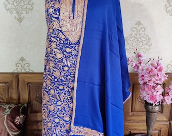 May include: A royal blue embroidered dress and matching shawl with gold and pink thread. The dress has a V-neck and a floral pattern. The shawl has a border of gold and pink thread.
