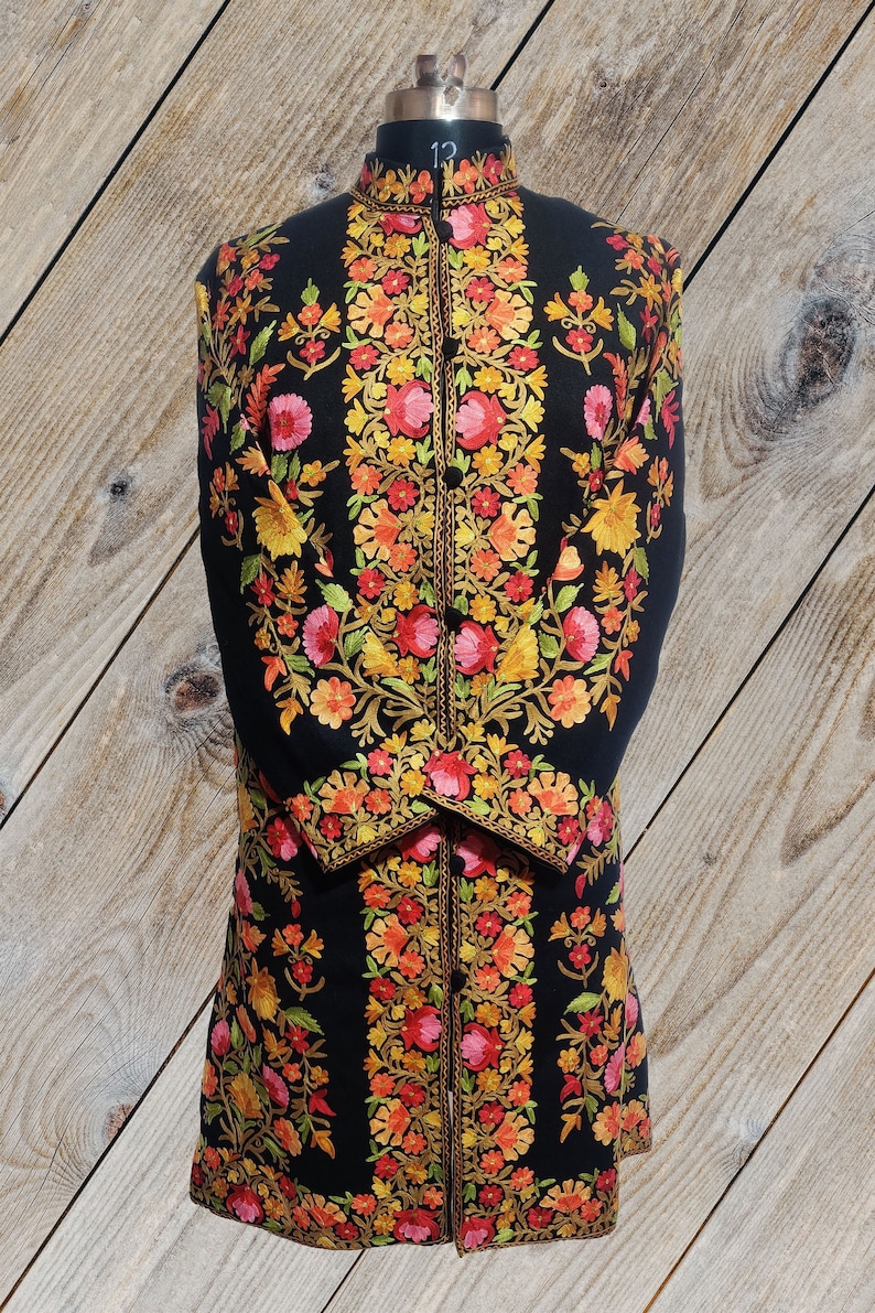 May include: A black long-sleeved jacket with intricate floral embroidery in shades of red, orange, yellow, and green. The jacket has a mandarin collar and a button closure.