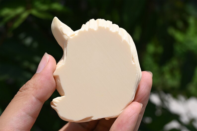 May include: A white ceramic sculpture of a unicorn head, with a detailed mane and horn.