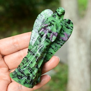 May include: Green, black and pink carved angel figurine made of green aventurine gemstone.