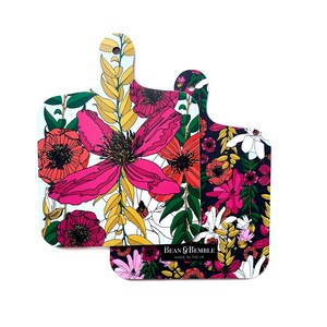 May include: Two floral patterned cutting boards with a white background and a black background. The white board has pink, red, and yellow flowers. The black board has pink, red, and white flowers. The text "Bean & Bemble Made in the UK" is on the black board.