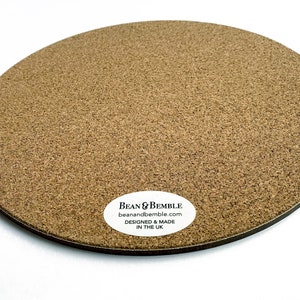 May include: A round cork coaster with a white label that reads "Bean & Bemble beanandbemble.com DESIGNED & MADE IN THE UK".