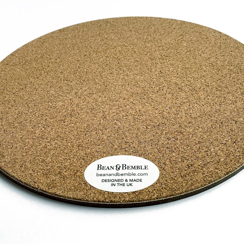 May include: A round cork coaster with a white label that reads "Bean & Bemble beanandbemble.com DESIGNED & MADE IN THE UK".