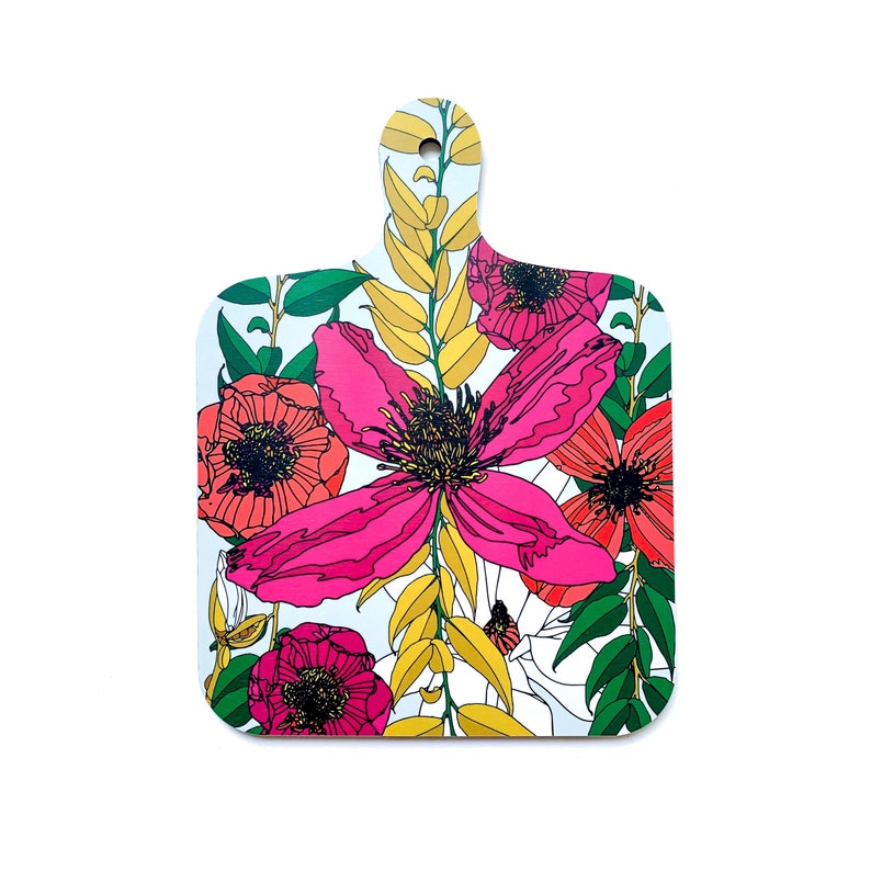 May include: A white cutting board with a floral design. The design features pink, red, and yellow flowers with green leaves on a white background.