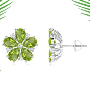 May include: A pair of silver earrings with a flower design. The flower is made of five pear-shaped green peridot gemstones surrounded by smaller round diamonds.