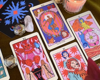 May include: A tarot card spread with ten cards, including the Devil, the World, Strength, and the Wheel of Fortune. The cards are illustrated with colorful, whimsical imagery and feature French text.