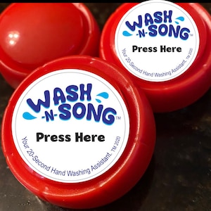 May include: Three red, circular hand-washing timers. Each timer has a white label with the words "WASH -N- SONG" in blue and white, and "Press Here" in black. The text "Your 20-Second Hand Washing Assistant. TM 2020" is also on the label.