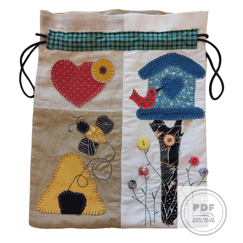 May include: A patchwork drawstring bag with a heart, birdhouse, and bee design. The bag features a red heart with white polka dots, a blue birdhouse, and a yellow bee. The bag is made of various fabrics and has a green plaid accent.