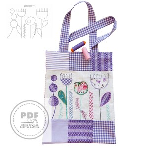 Puede incluir: Un bolso tote patchwork con un dise&ntilde;o floral. El bolso presenta un estampado de cuadros vichy en morado y blanco, con flores bordadas en varios colores. Dos carretes de hilo est&aacute;n encima. El bolso tiene el texto "PDF" y "MOIRA SEW LAB DIGITAL PATTERN".
