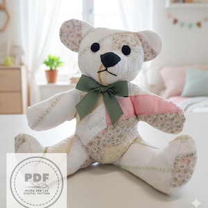 May include: A handmade patchwork teddy bear with a green bow. The bear is primarily white with floral and pink accents. The bear's eyes are black, and the nose is dark. The bear is sitting on a white surface.