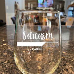 May include: A clear glass wine glass with the text "Sarcasm Loading..." printed on the side.