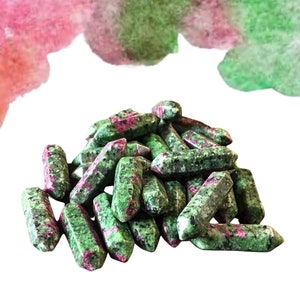 May include: A pile of green and pink ruby zoisite points. The points are smooth and polished, with a variety of shapes and sizes.