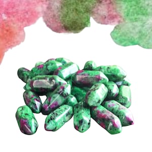 May include: A pile of green and pink ruby zoisite tumbled stones. The stones are smooth and polished, with a variety of shapes and sizes.