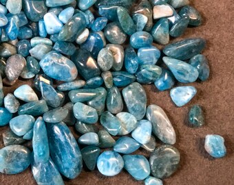 May include: A large pile of blue and green tumbled stones. The stones are smooth and have a variety of shapes and sizes.