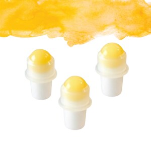 May include: Three white and yellow roll-on applicators with a yellow watercolour wash in the background. The applicators have a white base and a yellow, rounded top. The background is a bright yellow watercolour stroke.