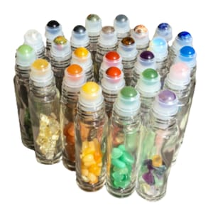 May include: A white ceramic mug with a black handle and the text "But First, Coffee" in a black, handwritten-style font. The mug is on a white surface.