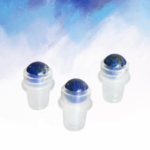 May include: Three clear glass roller bottles with a blue and gold stone top. The bottles are arranged in a triangular pattern against a white and blue watercolour background. The stone tops have a polished, rounded shape.
