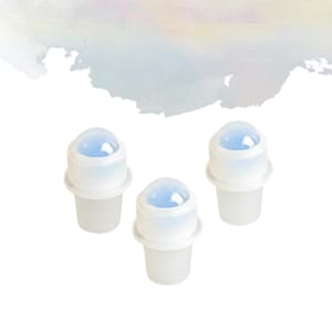 May include: Three clear roller bottles with white caps and a blue, dome-shaped top. The bottles are arranged on a white background, with a soft watercolour wash in the upper left corner.