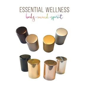 May include: Assortment of seven round metal bottle stoppers in various colors, including gold, silver, bronze, and rose gold. The stoppers are arranged in a semi-circle on a white background. The text "ESSENTIAL WELLNESS body. mind. spirit" is displayed above the stoppers.