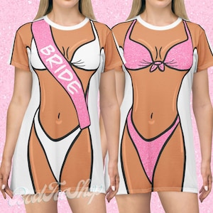 May include: Two white and tan dresses with a cartoon bikini design. One dress has a pink sash that says "BRIDE". The other dress has a pink glitter bikini design. The dresses have short sleeves and a white background.