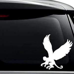 May include: White vinyl decal of a monkey with wings. The monkey is in a flying pose with its wings spread out.