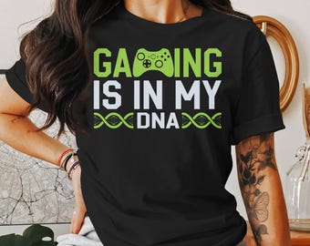May include: Black t-shirt with green text that reads "Gaming is in my DNA" and a green video game controller graphic.