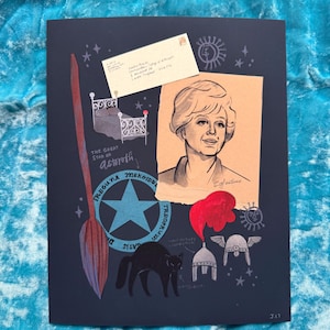May include: Dark blue art print featuring a portrait of a woman, a black cat, a broom, and other whimsical illustrations. The print includes text and a vintage-style envelope. The artwork has a vintage aesthetic with a touch of fantasy.