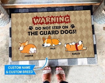 May include: A brown doormat with the text "WARNING DO NOT STEP ON THE GUARD DOGS!" and three cartoon dogs with the names "Milo", "Cooper", and "Barley" printed below them.
