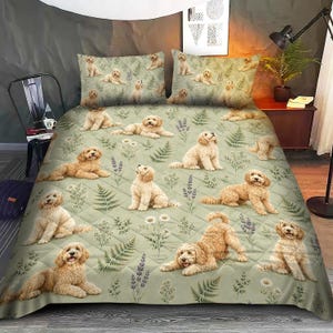May include: A quilted bedspread and two matching pillowcases in a light sage green color, featuring a repeating pattern of golden-brown doodle dogs interspersed with illustrations of green fern leaves, lavender sprigs, and small white daisy flowers.