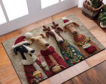 Op de afbeelding: Een rechthoekige beige deurmat met vier honden gekleed in feestelijke vakantiekleding. De honden dragen kerstmutsen, sjaals en truien, met één hond versierd met een kerstboomontwerp. De mat ligt op een houten vloer.