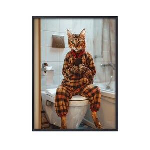May include: A cat wearing plaid pajamas sits on a toilet and uses a smartphone.