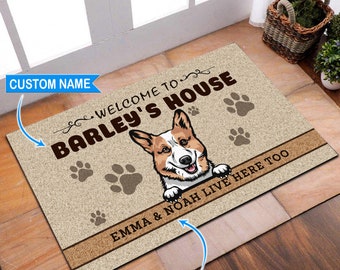 May include: Welcome to Barley's House doormat featuring a cartoon image of a corgi dog peeking over the top. The text "Emma & Noah live here too" is printed on the mat.