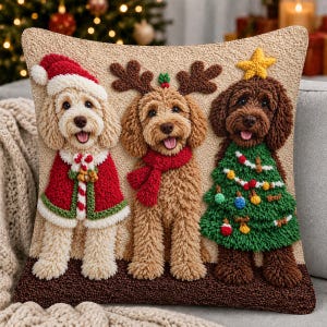 May include: A square throw pillow featuring a textured, punch-needle design of three dogs. The left dog wears a Santa hat and red cape, the center dog has reindeer antlers and a red scarf, and the right dog wears a green Christmas tree costume.