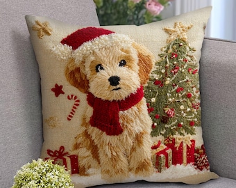 May include: Embroidered Christmas throw pillow featuring a puppy wearing a Santa hat and red scarf. The pillow also depicts a Christmas tree, presents, and candy cane on a beige background. A festive holiday home decor item.