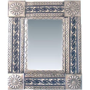 May include: A rectangular mirror with a decorative silver frame. The frame features a repeating pattern of blue and silver tiles with floral and scroll designs. The corners have square silver tiles with a floral motif.