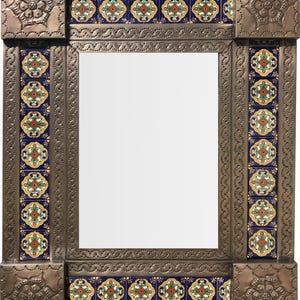 May include: A rectangular mirror with a decorative frame. The frame is metal with a hammered texture and features colourful ceramic tiles with floral patterns. The corners have embossed floral designs.