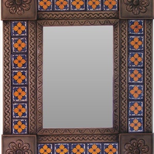 May include: A decorative mirror with a brown metal frame and a border of blue and orange tiles. The tiles feature a floral design.
