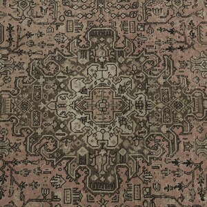 May include: Close-up of a vintage rug with an elaborate, symmetrical design. The rug's colour palette includes muted tones of dusty rose, brown, and cream. The pattern incorporates floral and geometric motifs.